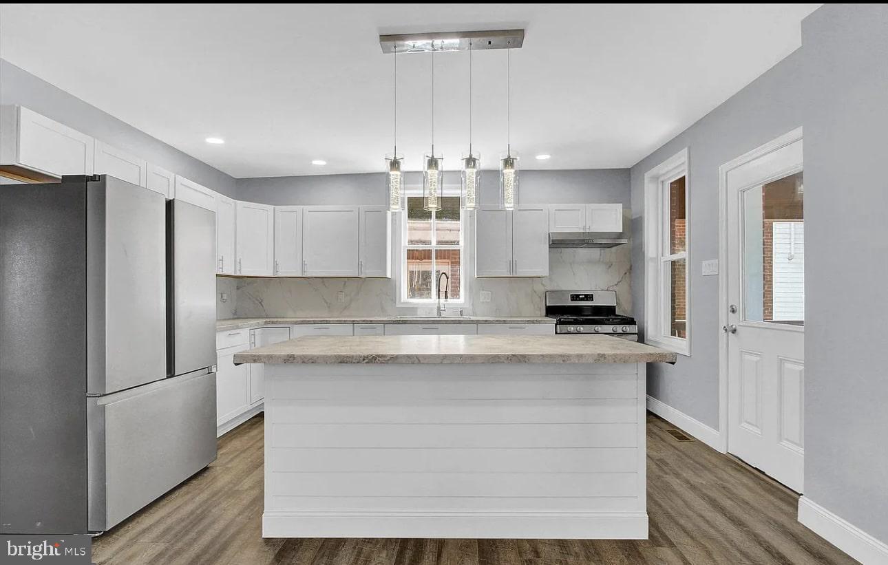 56 North Main Street Spring Grove, PA 17362 - Photo 6 of 25 a kitchen with kitchen island a sink stainless steel appliances and cabinets