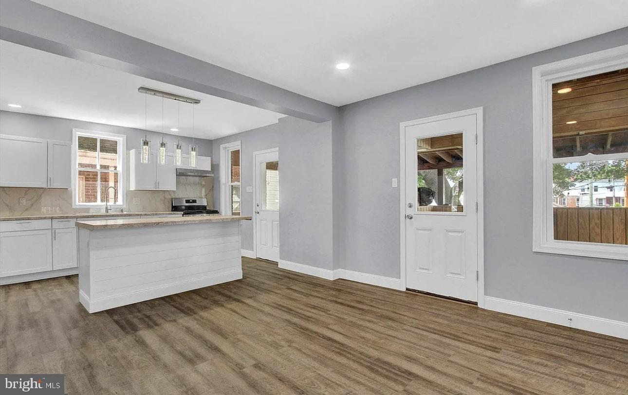 56 North Main Street Spring Grove, PA 17362 - Photo 7 of 25 a kitchen with wooden floors and white cabinets