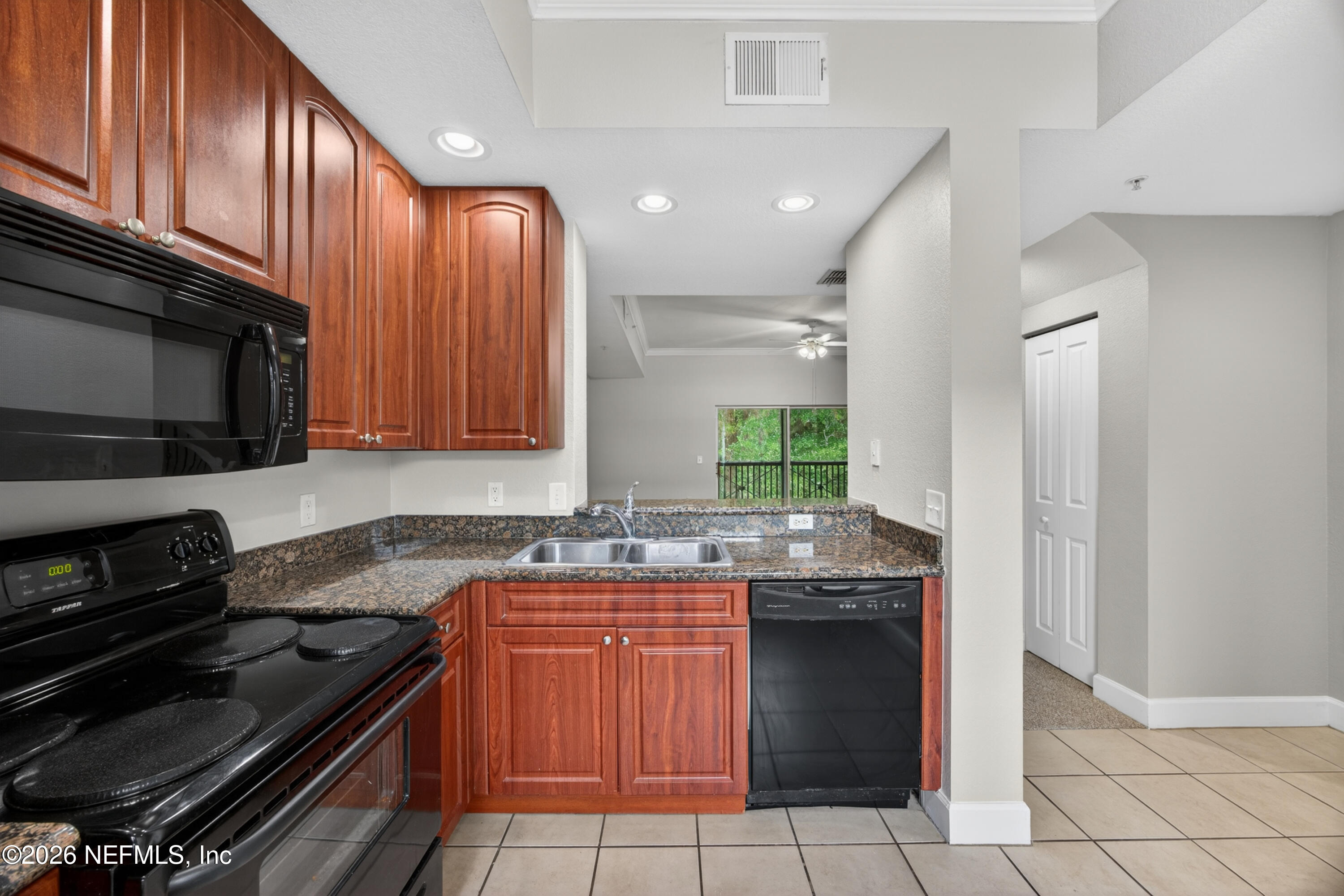 9745 Touchton Road, Unit 1224 Jacksonville, FL 32246 - Photo 6 of 22 a kitchen with a sink stove top oven and cabinets