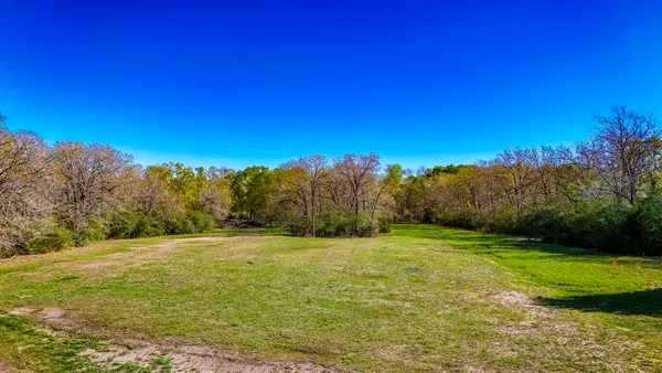 a swimming pool with trees in the background