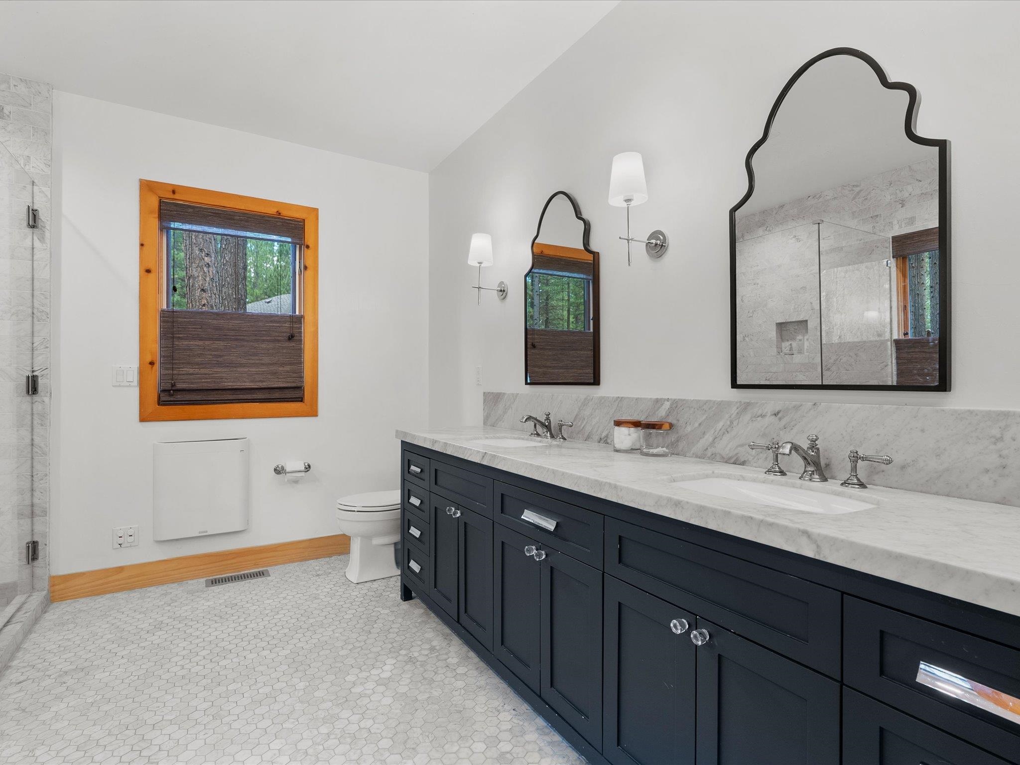 355 Quail View Circle Clio, CA 96106 - Photo 32 of 48 a bathroom with a double vanity sink and a mirror