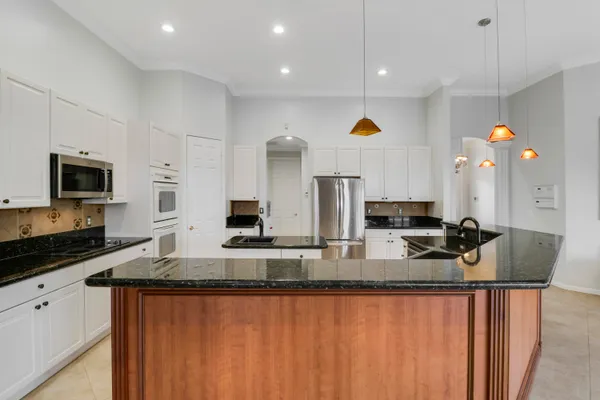 a kitchen with stainless steel appliances granite countertop a stove and a sink