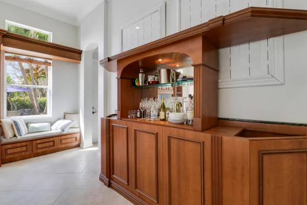 a bed sitting in a spacious bedroom next to a window