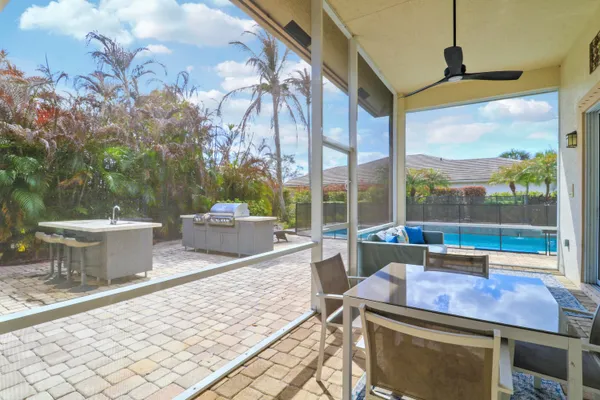 a view of a patio with a table and chairs