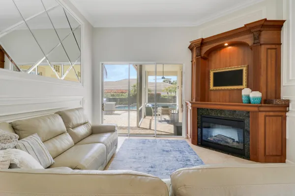 a living room with furniture and a floor to ceiling window