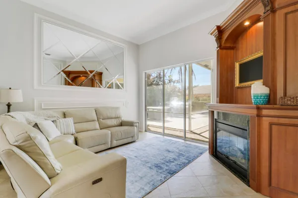 a living room with furniture a fireplace and a chandelier