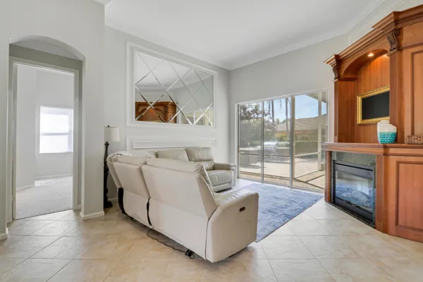 a living room with furniture and a large mirror
