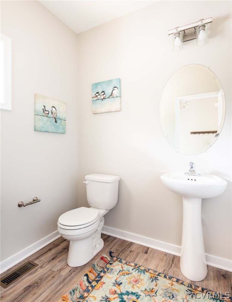 4936 Lancewood Road Chesterfield, VA 23832 - Photo 12 of 24 a white toilet sitting next to a bathroom sink