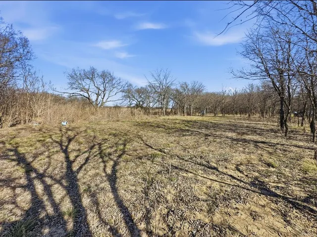 a view of mountain with sunset in background