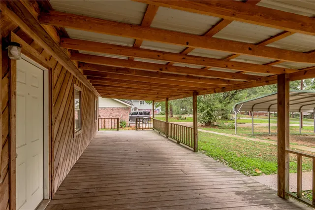 a view of a porch of a house with wooden floor