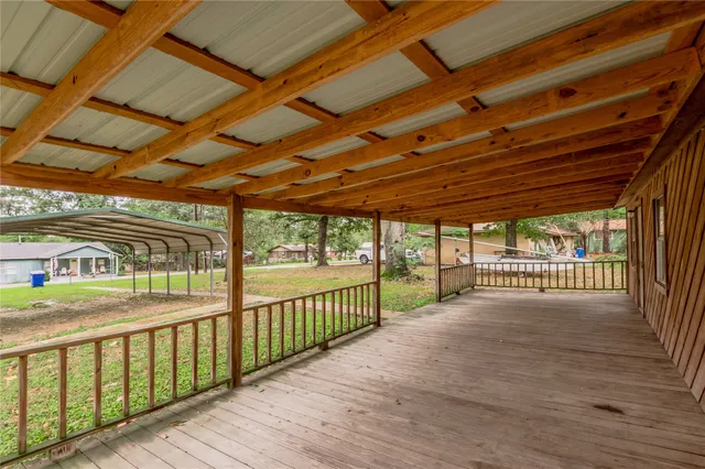a view of a porch with wooden floor