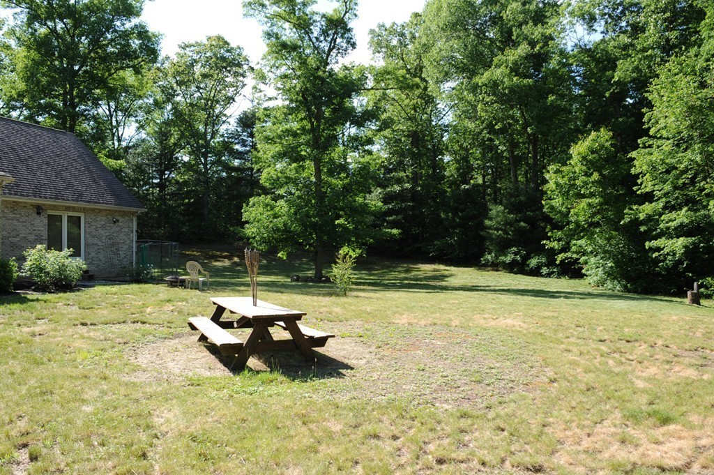 25 Robinson Road Palmer, MA 01069 - Photo 7 of 30 a backyard of a house with table and chairs