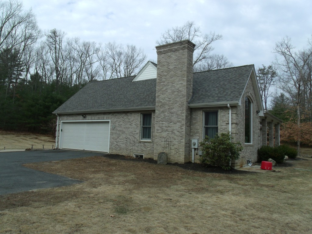 25 Robinson Road Palmer, MA 01069 - Photo 8 of 30 a front view of a house with a yard and garage