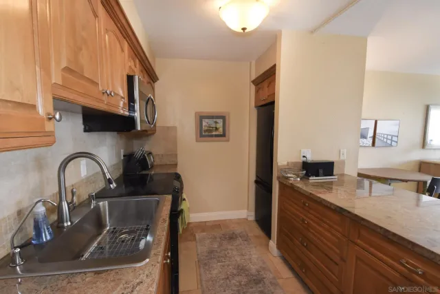 a kitchen with a sink and a stove top oven