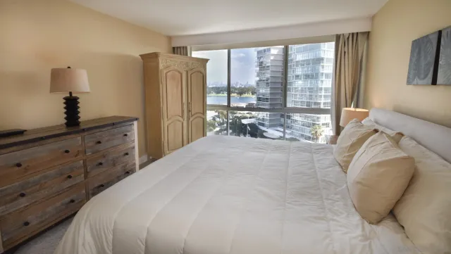 a spacious bedroom with a bed and a dresser