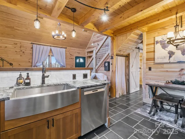 a kitchen with stainless steel appliances granite countertop a sink a stove and cabinets