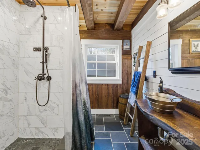 a bathroom with a sink a toilet and a shower