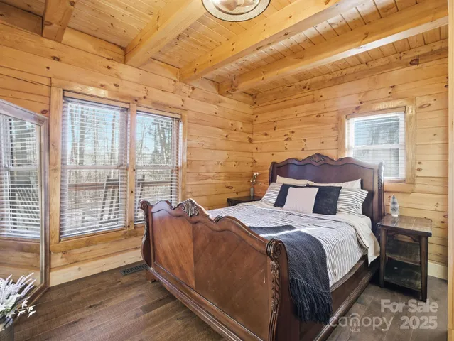 a bed sitting in a bedroom next to a window