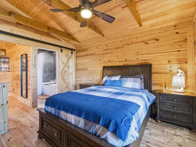 a bedroom with a bed and a dresser next to a window