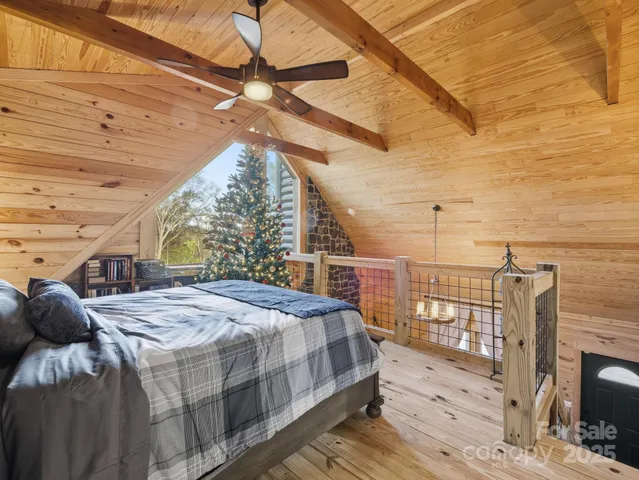 a bedroom with a bed a chandelier and dresser