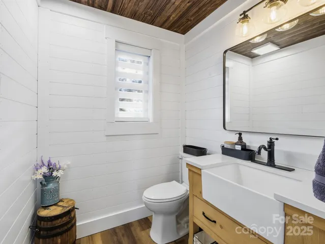 a bathroom with a sink toilet and a mirror