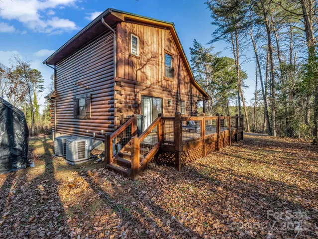 a backyard of a house with barbeque oven table and chairs