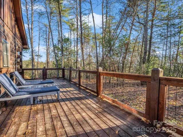 a view of balcony with wooden floor and fence