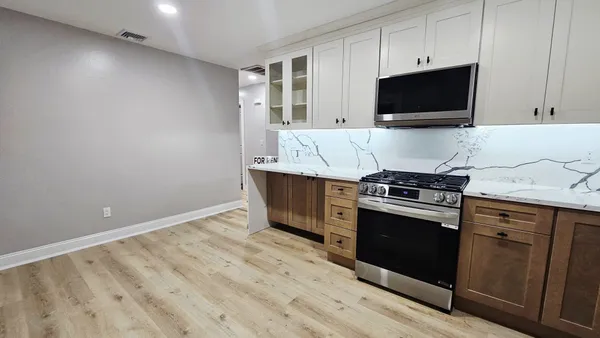 a view of room with wooden floor and closet
