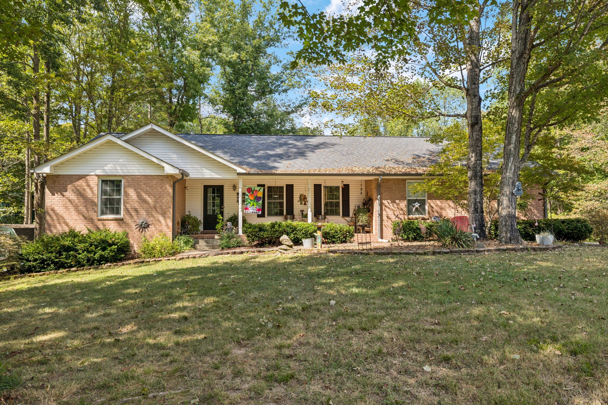 1060 Satterwhite Road Ashland City, TN 37015 - Photo 1 of 38 a front view of a house with a garden