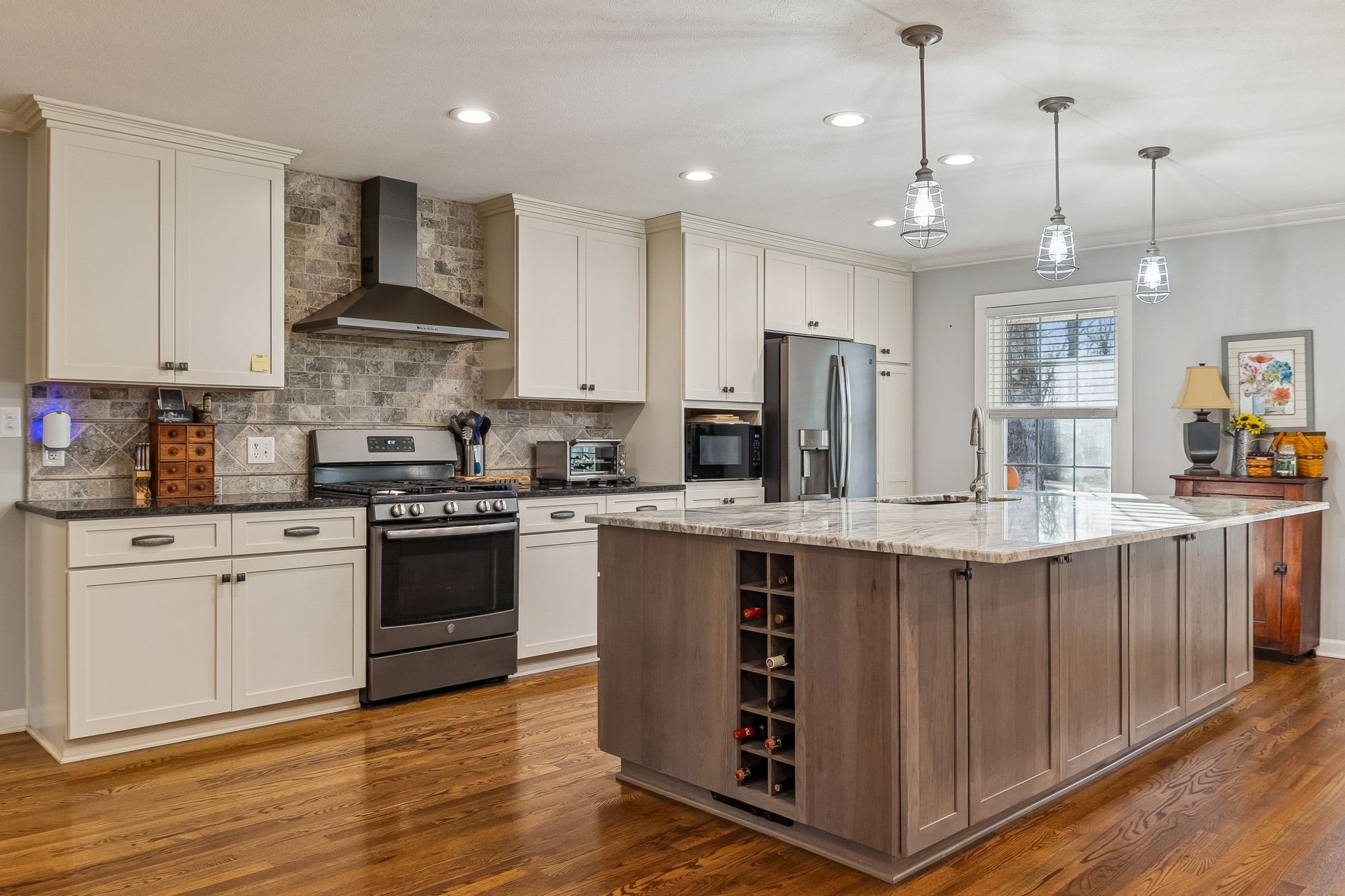 1060 Satterwhite Road Ashland City, TN 37015 - Photo 12 of 38 a kitchen with stainless steel appliances granite countertop a stove a sink dishwasher a refrigerator and white cabinets with wooden floor
