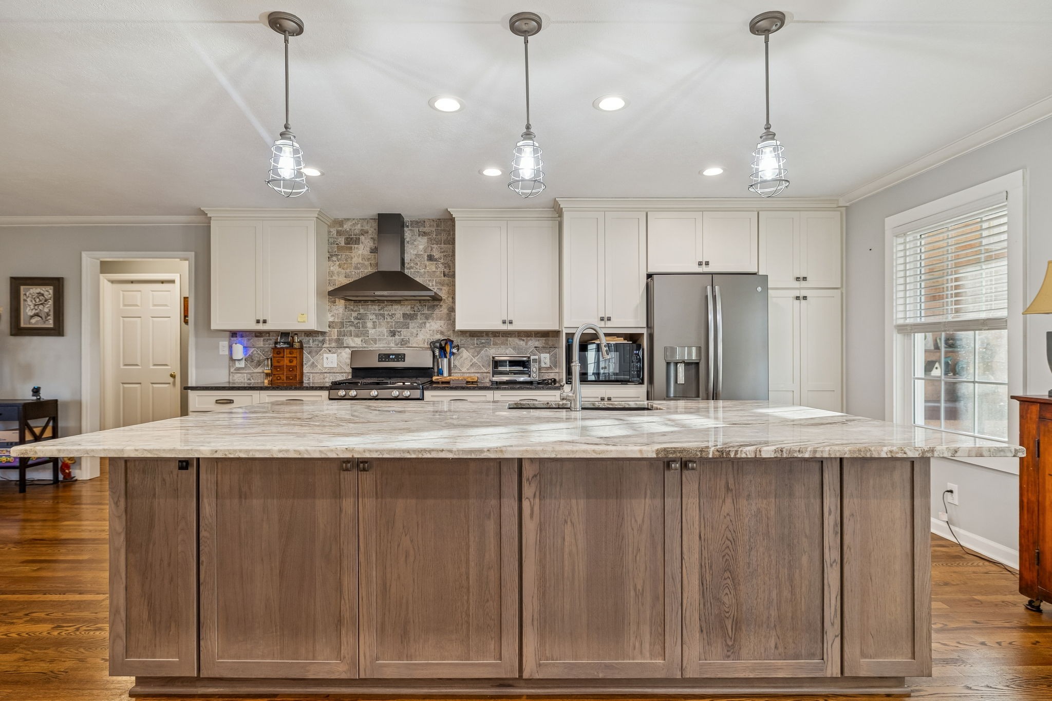 1060 Satterwhite Road Ashland City, TN 37015 - Photo 13 of 38 a large kitchen with granite countertop a sink a center island stainless steel appliances and cabinets