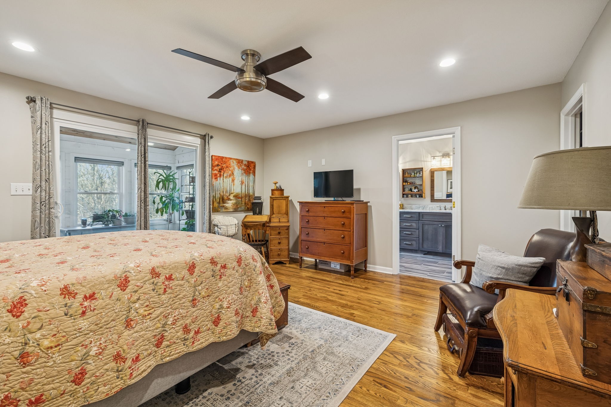 1060 Satterwhite Road Ashland City, TN 37015 - Photo 19 of 38 a spacious bedroom with a bed a table and chair