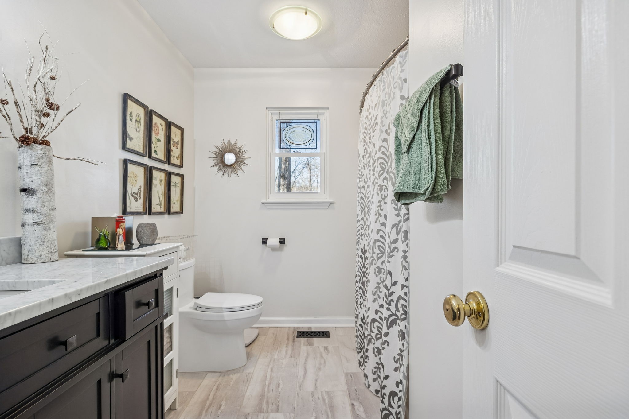 1060 Satterwhite Road Ashland City, TN 37015 - Photo 26 of 38 a bathroom with a granite countertop sink a toilet and shower