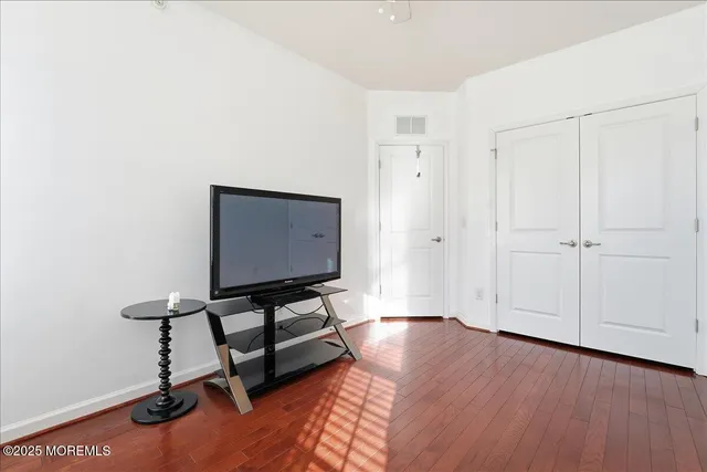 a view of a workspace with furniture and wooden floor