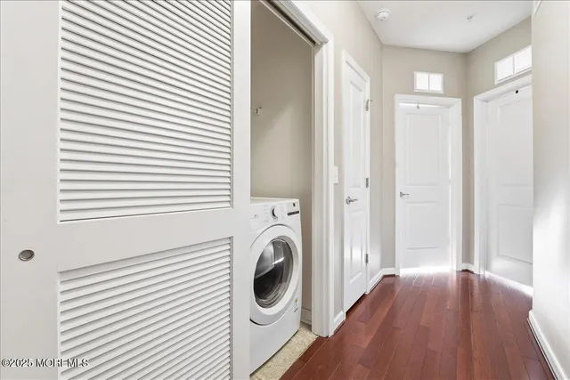 a view of a hallway with washer and dryer
