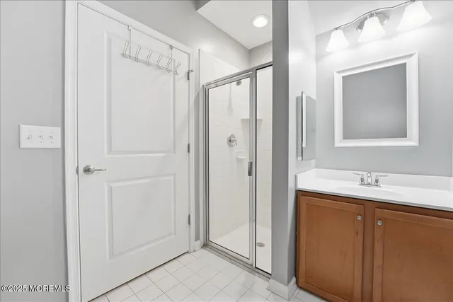 a bathroom with a shower sink and mirror
