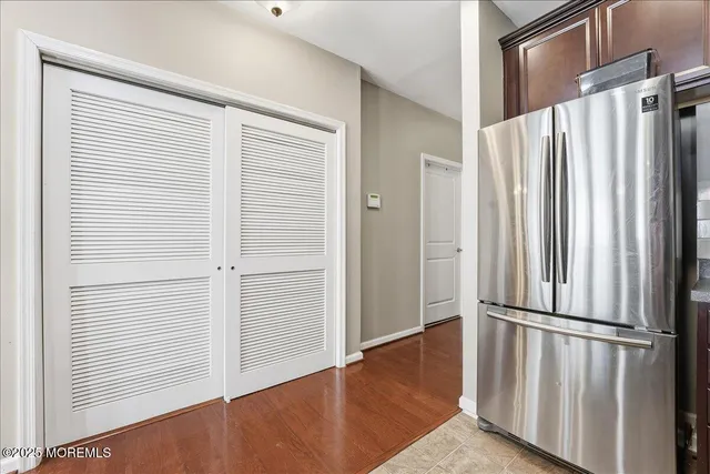 an entryway with wooden floor and stairs