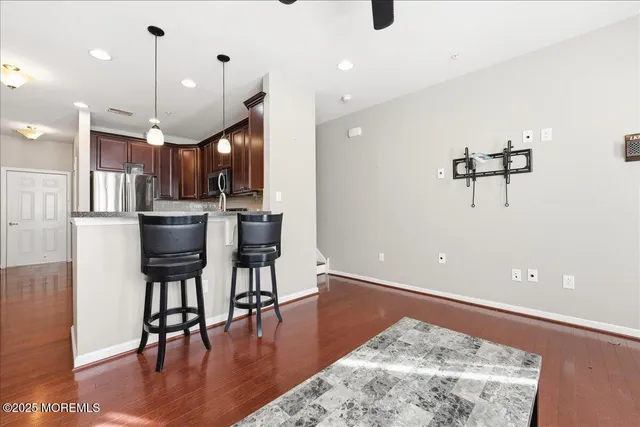 a view of kitchen with cabinets and wooden floor