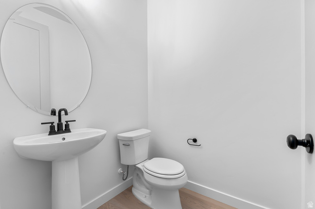 1869 South 2425 West Ogden, UT 84401 - Photo 15 of 22 Half bath featuring toilet and light wood-type flooring
