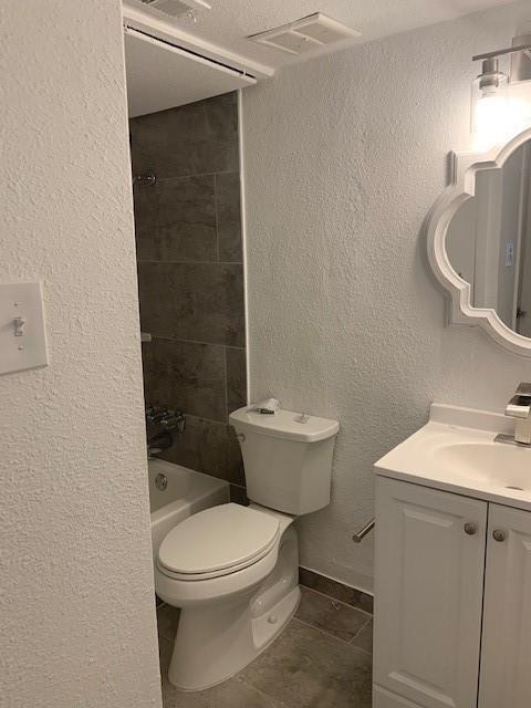 5721 Harvest Hill Road, Unit 1036 Dallas, TX 75230 - Photo 5 of 9 a white toilet sitting next to a bathroom sink and vanity