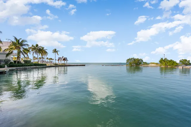 a view of a lake with table and chairs