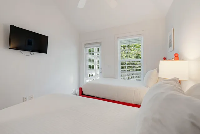 a bedroom with a bed and a flat screen tv