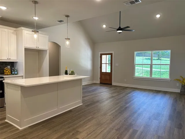 a view of room with window and wooden floor