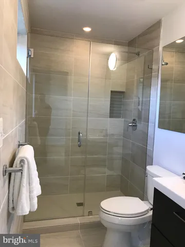 a bathroom with a toilet and a shower