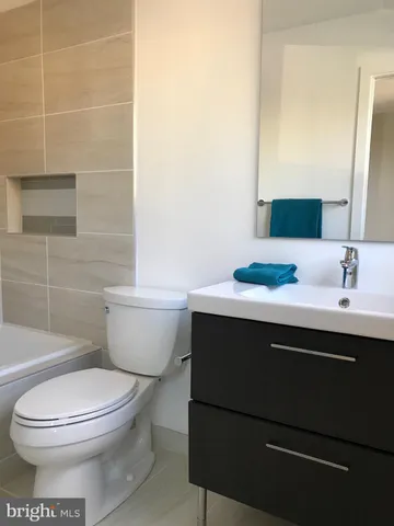 a bathroom with a sink a toilet and mirror