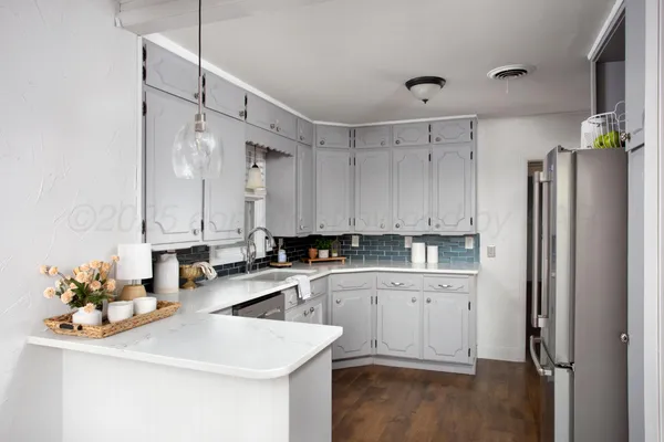 a kitchen with a sink appliances and cabinets