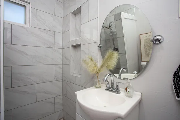 a bathroom with a sink and mirror