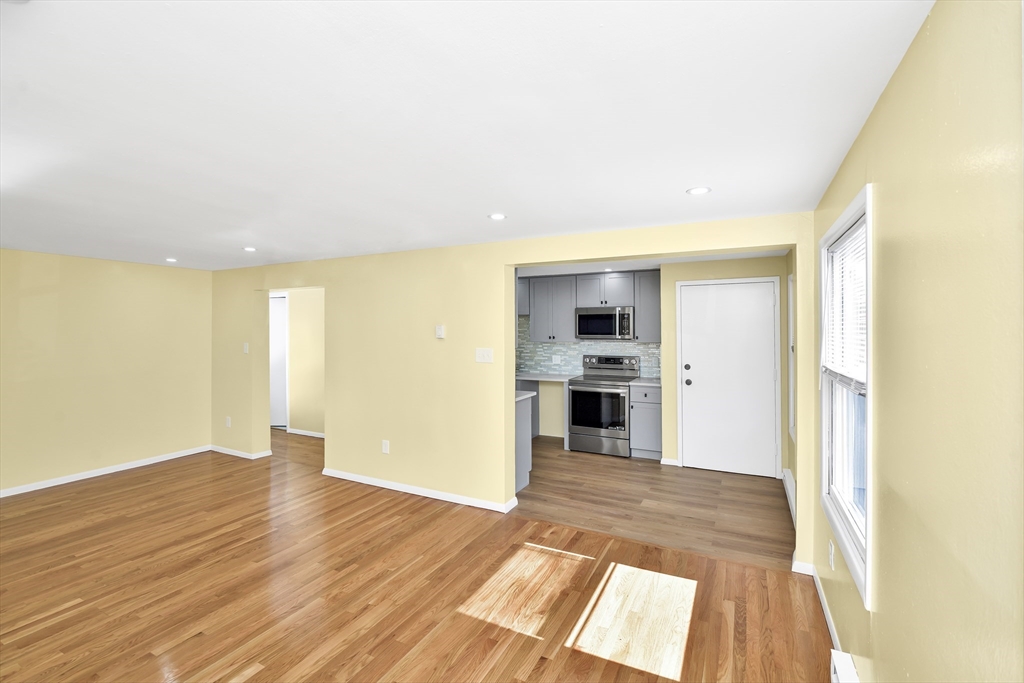 11 Greendale Road, Unit 2 Boston, MA 02126 - Photo 2 of 25 a view of a big room with wooden floor and windows
