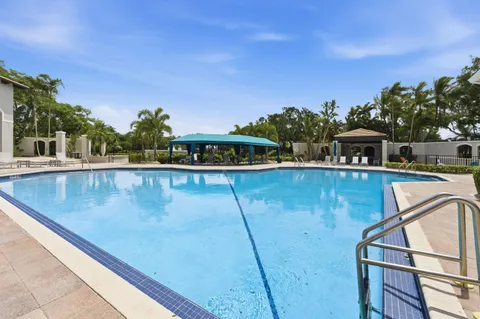a view of a swimming pool with outdoor seating