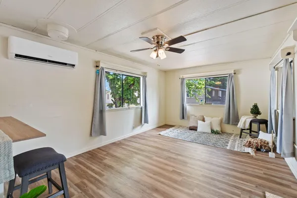 a bedroom with a bed and wooden floor